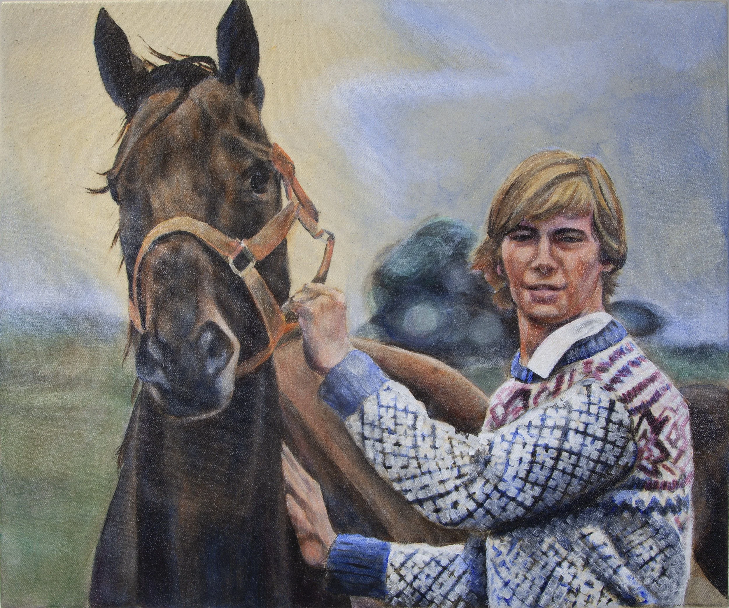 A young boy with blonde hair, wearing a colorful sweater, stands next to a brown horse, holding its bridle, on a grassy landscape with a cloudy sky.