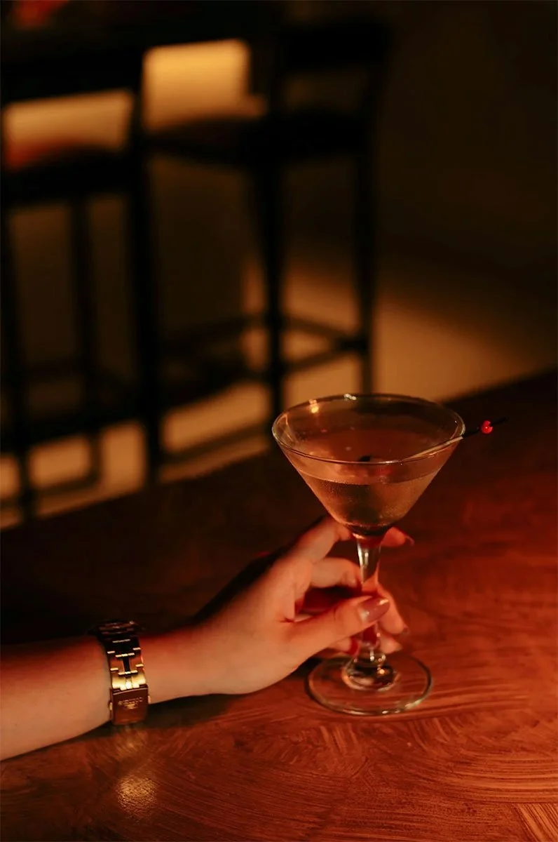 a hand holding a drink