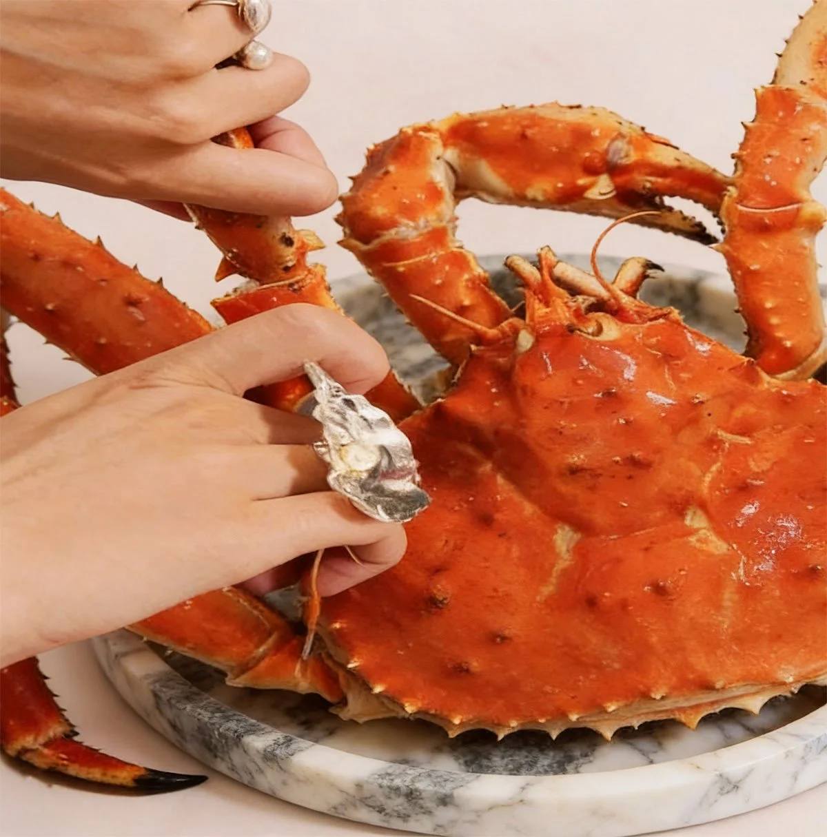 hands breaking a crab leg