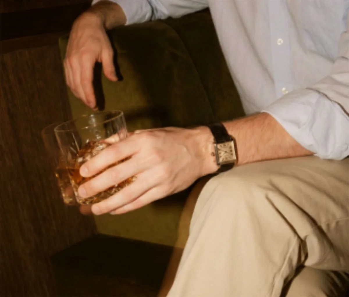 a male hand holding a drink