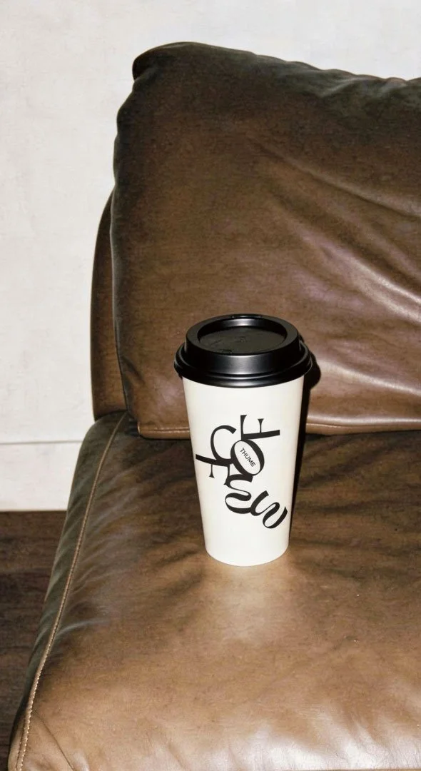 a thume coffee cup on a couch