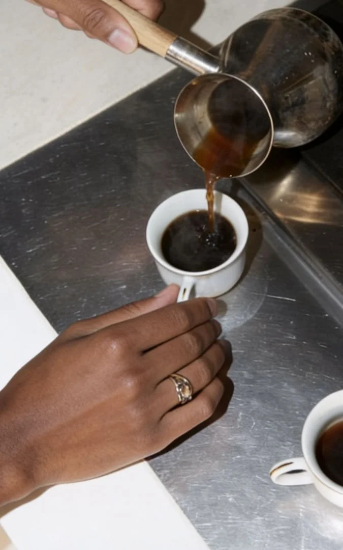 hands pouring coffee