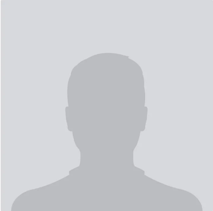 A blank gray silhouette of a therapist's head and shoulders.