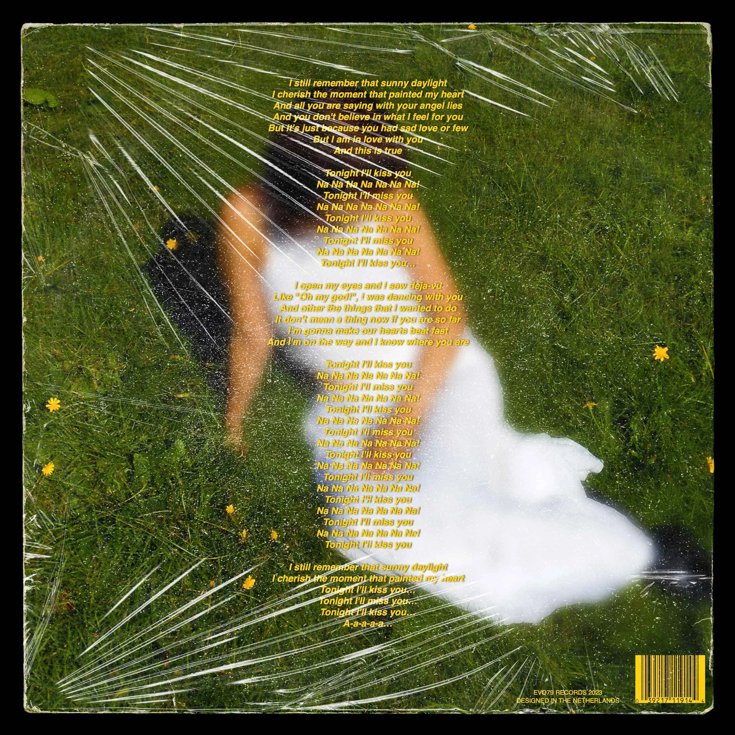 The cover of a vinyl record with a green grassy background and a blurred woman in a white dress lying down. Overlaid on the image is text of song lyrics in yellow.