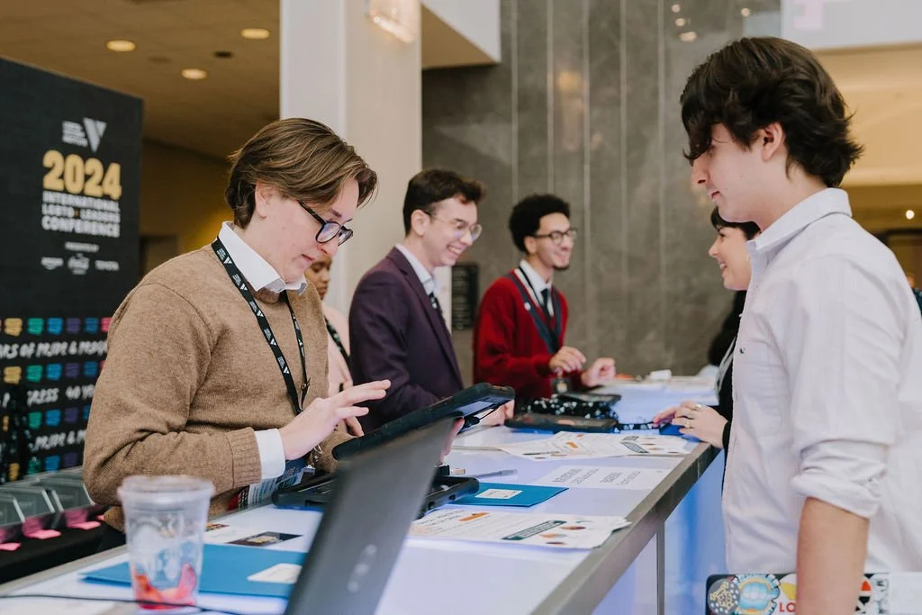 People at a registration or information desk at a conference or event