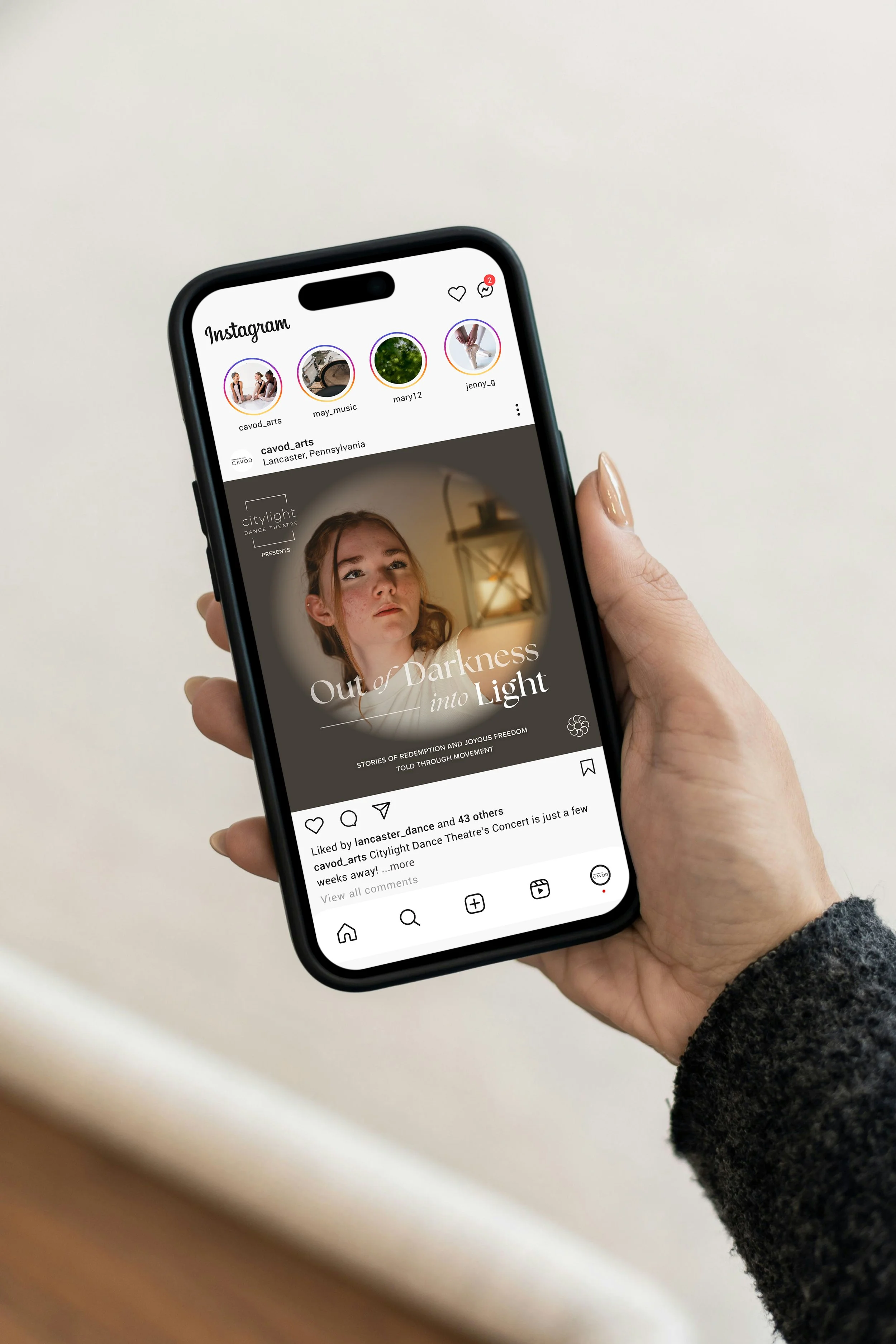 Out of Darkness into Light Show social post on Instagram post, showed on smart phone held in a womans hand.