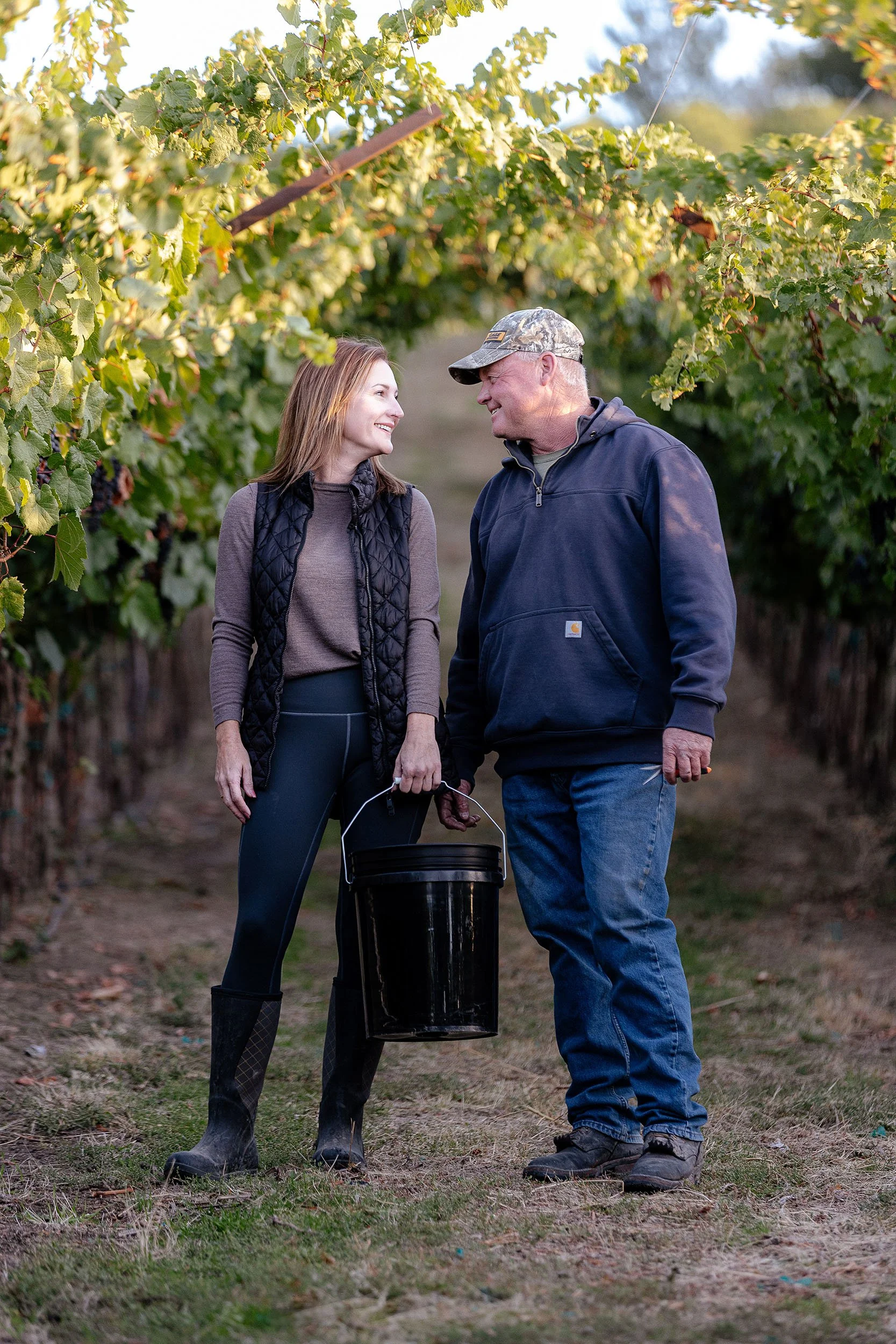 Couple walking through estate vineyard at Kustlijn Cellars in Idaho’s Eagle Foothills AVA