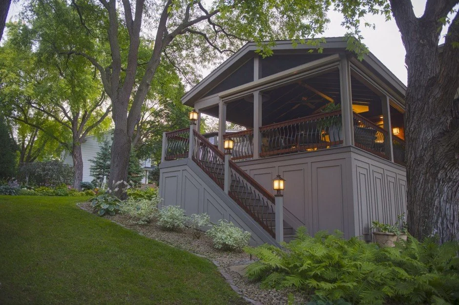 Elevated wooden deck remodel in Wayzata  with stairs in a lush garden