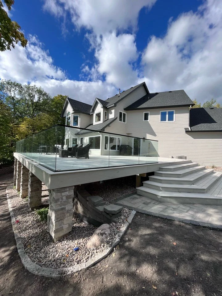 Modern house remodel in Victoria remodel in Excelsior with large wooden deck and glass railing