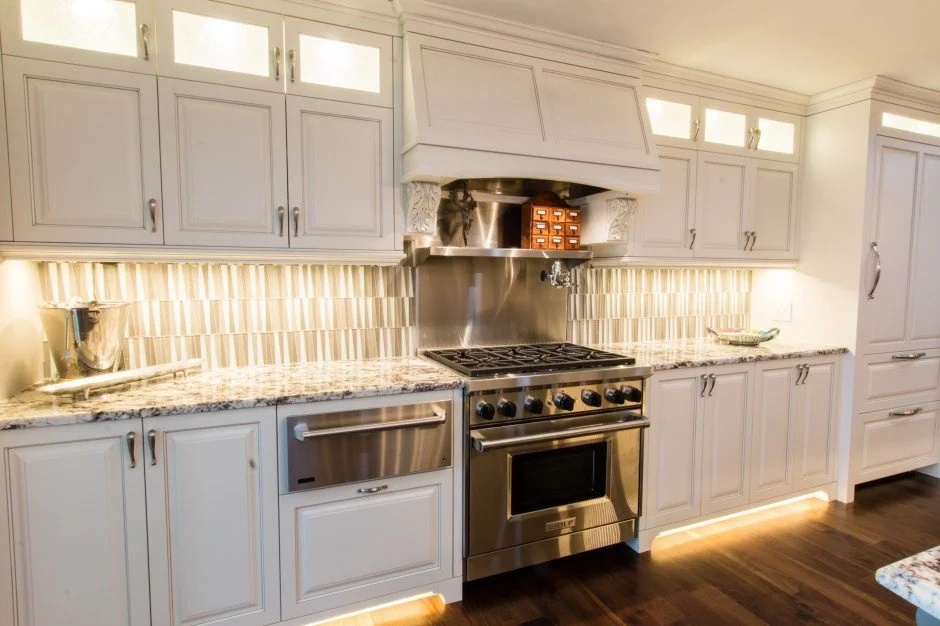 Modern kitchen remodel in Minnetonka with white cabinets, stainless steel appliances, and granite countertops.