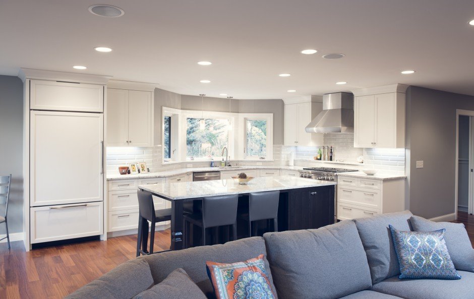 Modern kitchen  remodel in Excelsior with white cabinets, island, and stainless steel appliances.