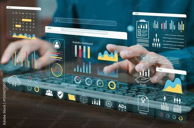 Person using a laptop with digital analytics dashboards and charts overlaid, displaying various business and data visualization graphics.