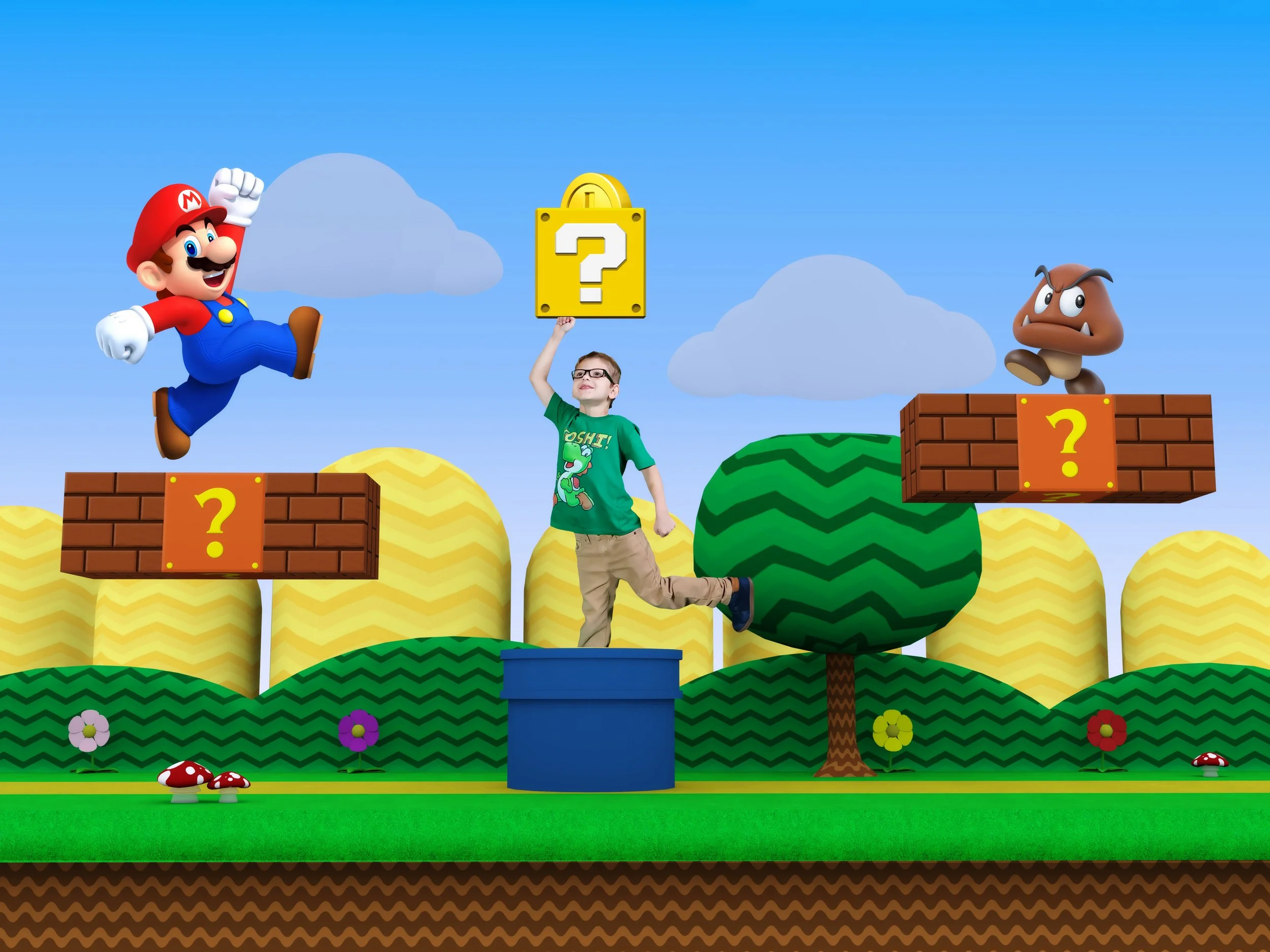 A child in a green T-shirt hitting a yellow question mark block from Super Mario, jumping on a blue pipe in a colorful, cartoon-style video game landscape with Mario jumping to the left in a Marion Themed Birthday Photography session.
