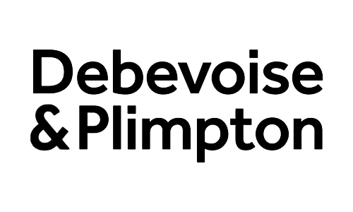 A person driving a motorcycle on a dirt hill during daytime with a clear sky.