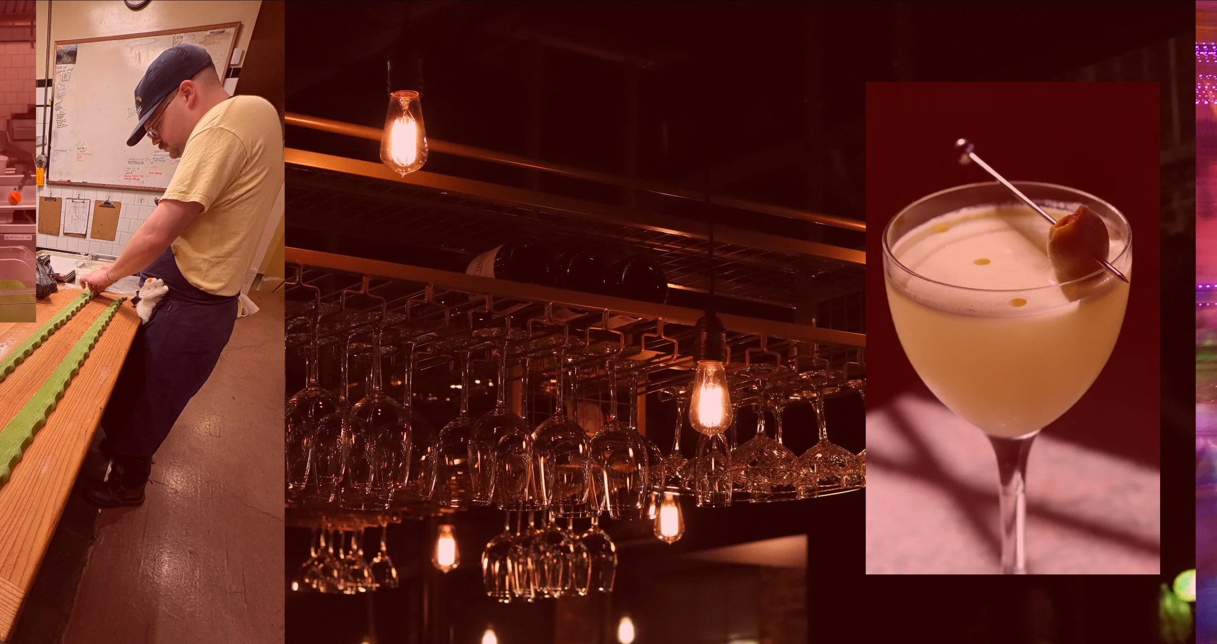 A person in a yellow shirt, black pants, and a cap preparing desserts in a restaurant, with a row of empty wine glasses hanging upside down, a warm orange hanging light, and a cocktail with an olive garnish.