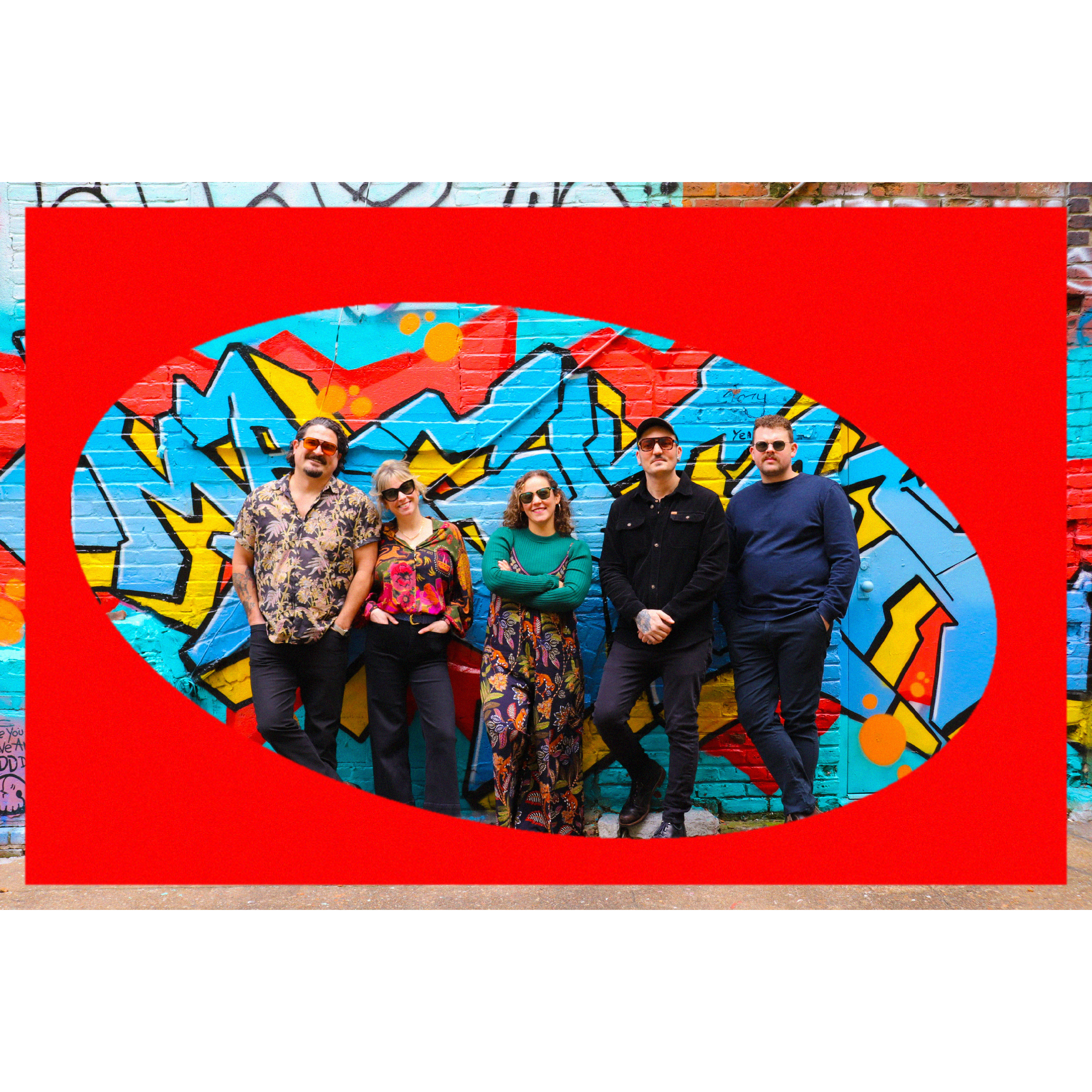 Group of five people, and owners of BONA FIDE, standing in front of a colorful graffiti background, posing for a photo.