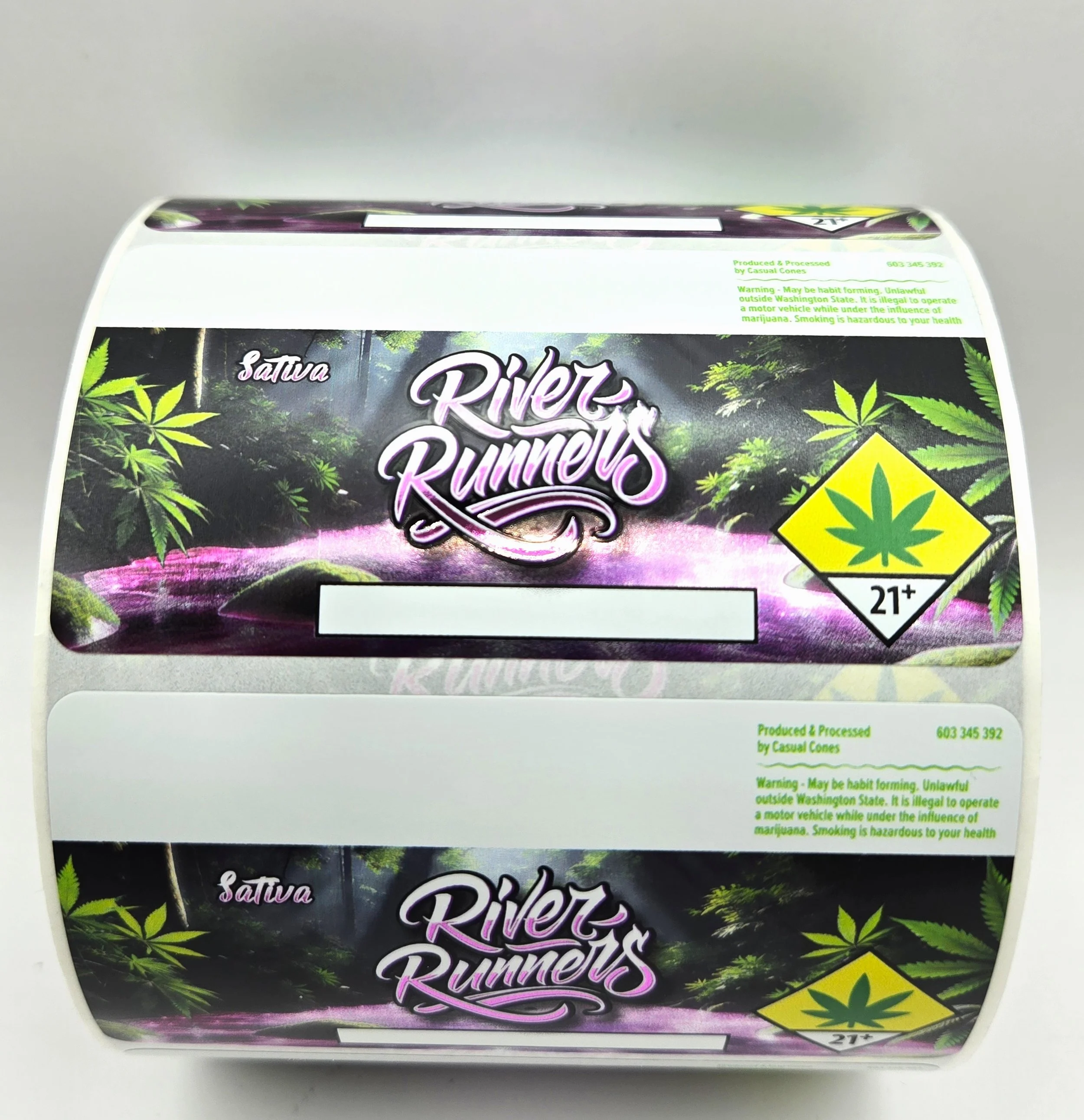 Roll of cannabis packaging labeled 'River Runners' with marijuana leaf symbols, bright green and purple design, 21+ age warning, and cannabis imagery.