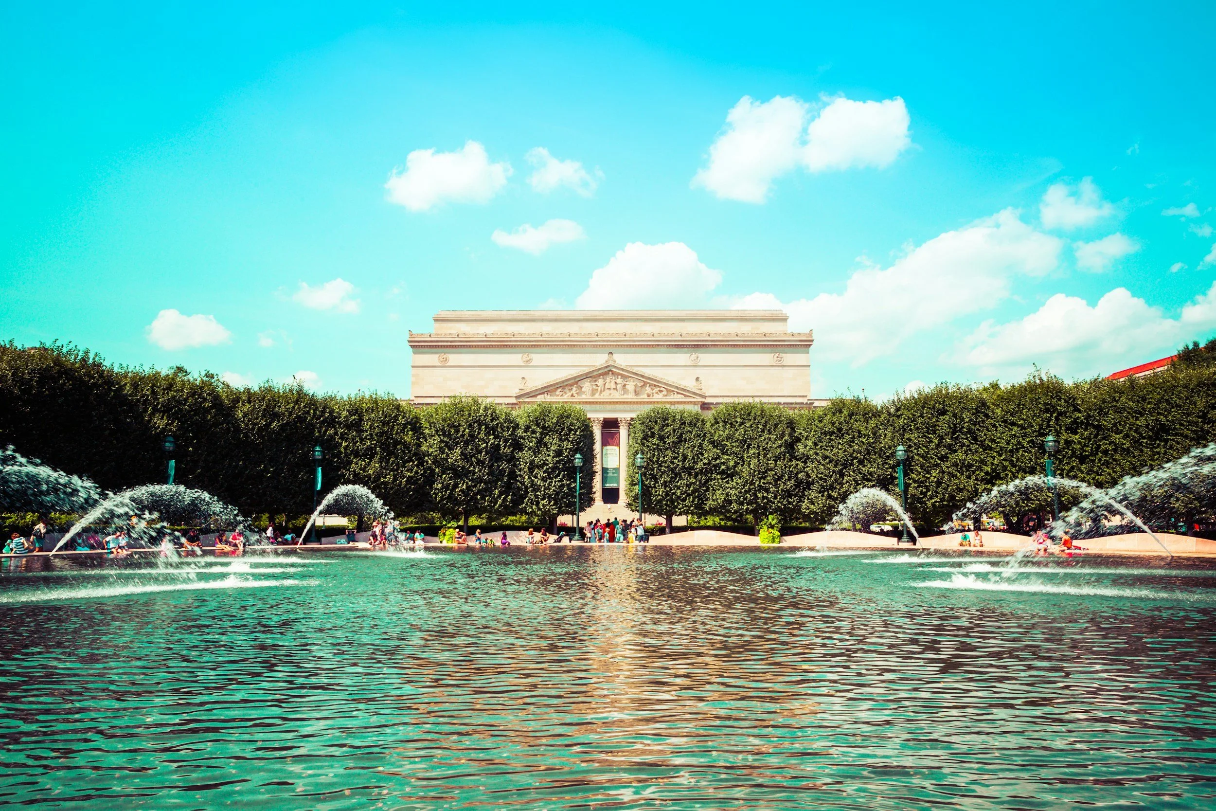 Exterior view of the National Gallery of Art and surrounding fountain.