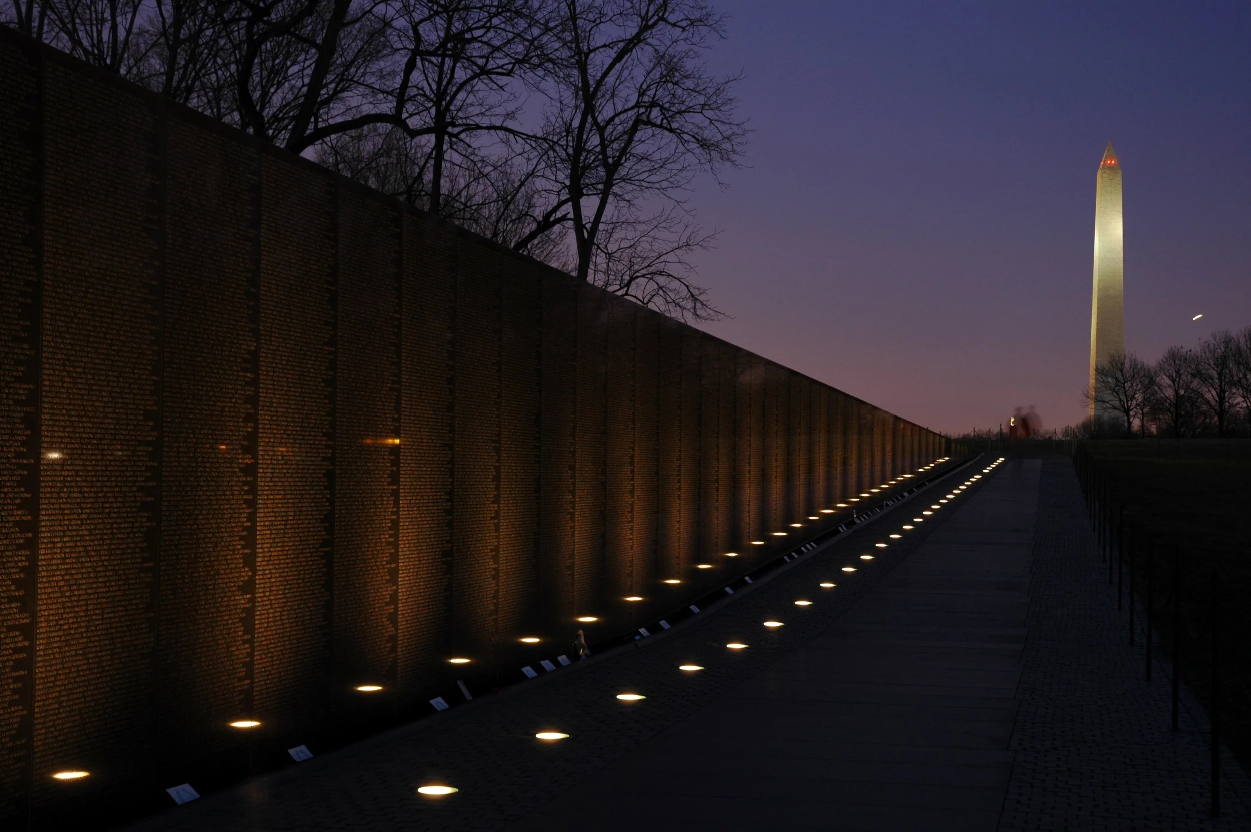 A view of the Vietnam Memorial and Washington Monument at night time