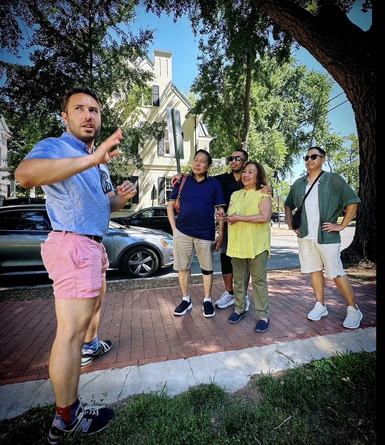Friends in DC tour guide Alex Domini is taking a group around Washington, DC on a tour. The group is happy and smiling as Alex is explaining important and fun historical facts.