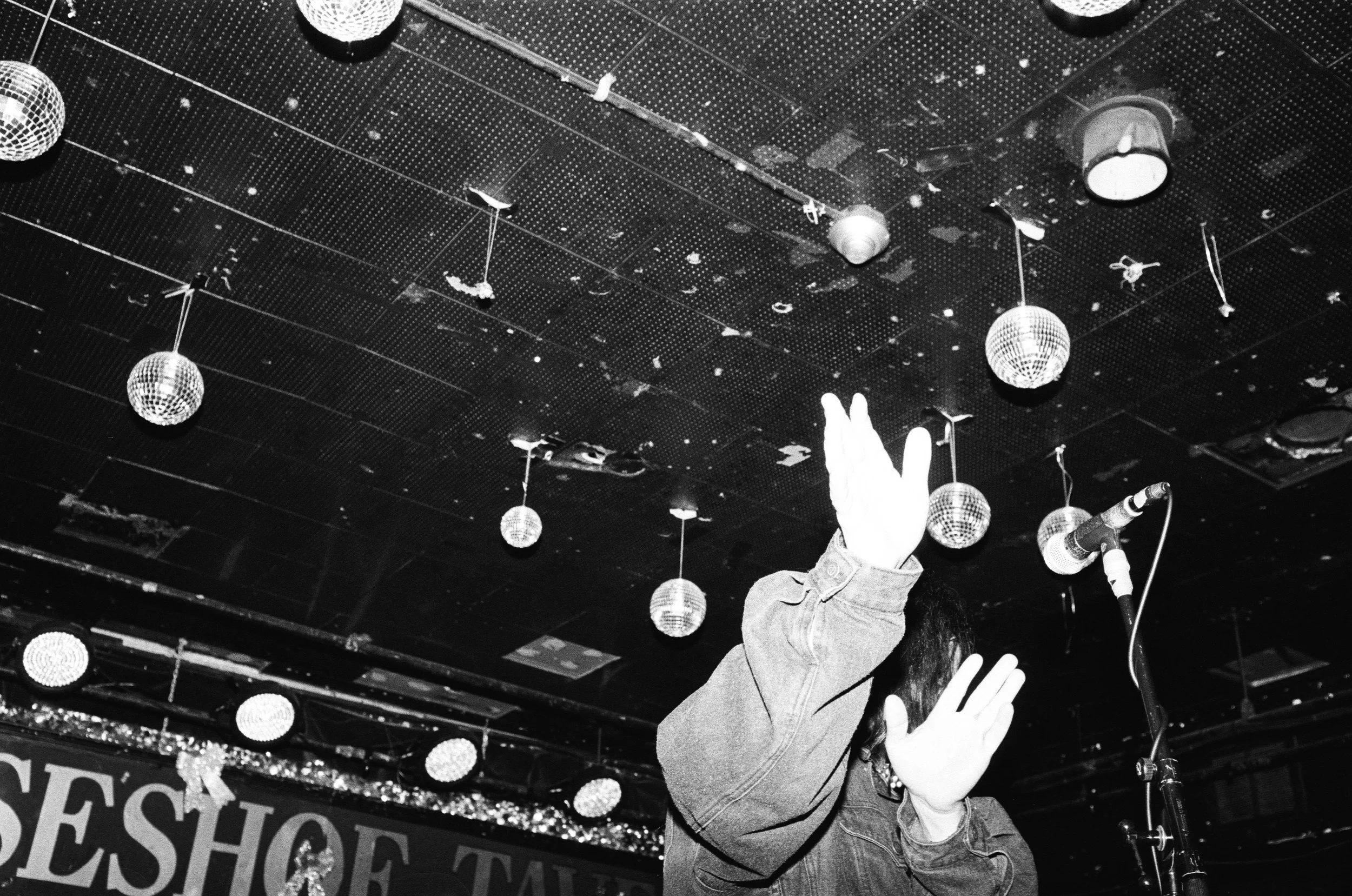 Singer performing with hands in air.