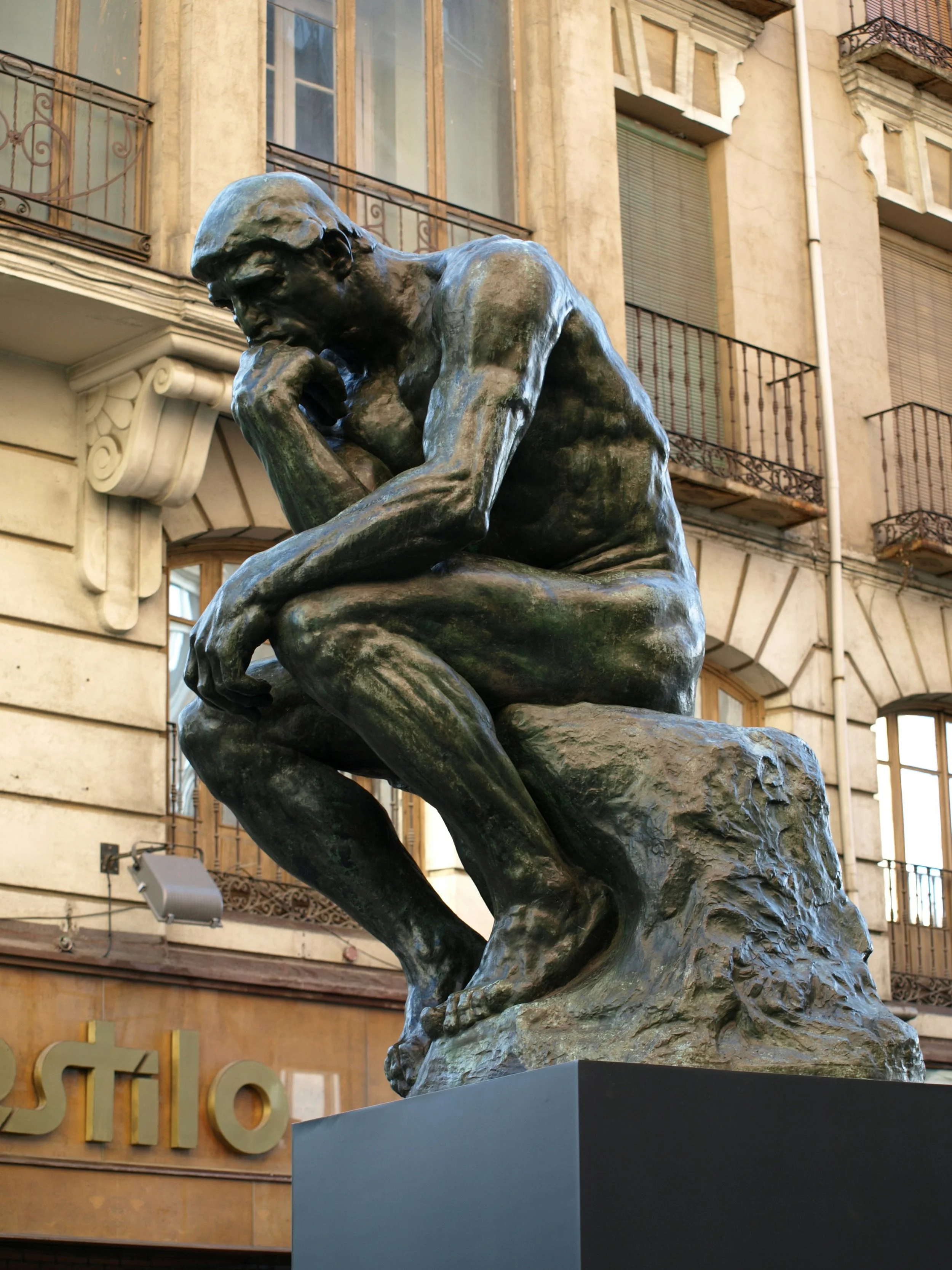 Statue in thoughtful pose symbolizing chronic neck pain, stress, and postural tension