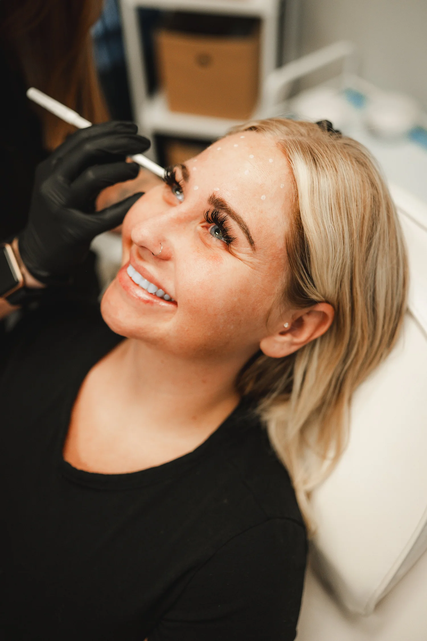 A smiling client during facial treatment planning at Luke’s Well in Scottsburg.