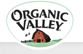 Logo of Organic Valley showcasing a red barn with a black roof and a white background