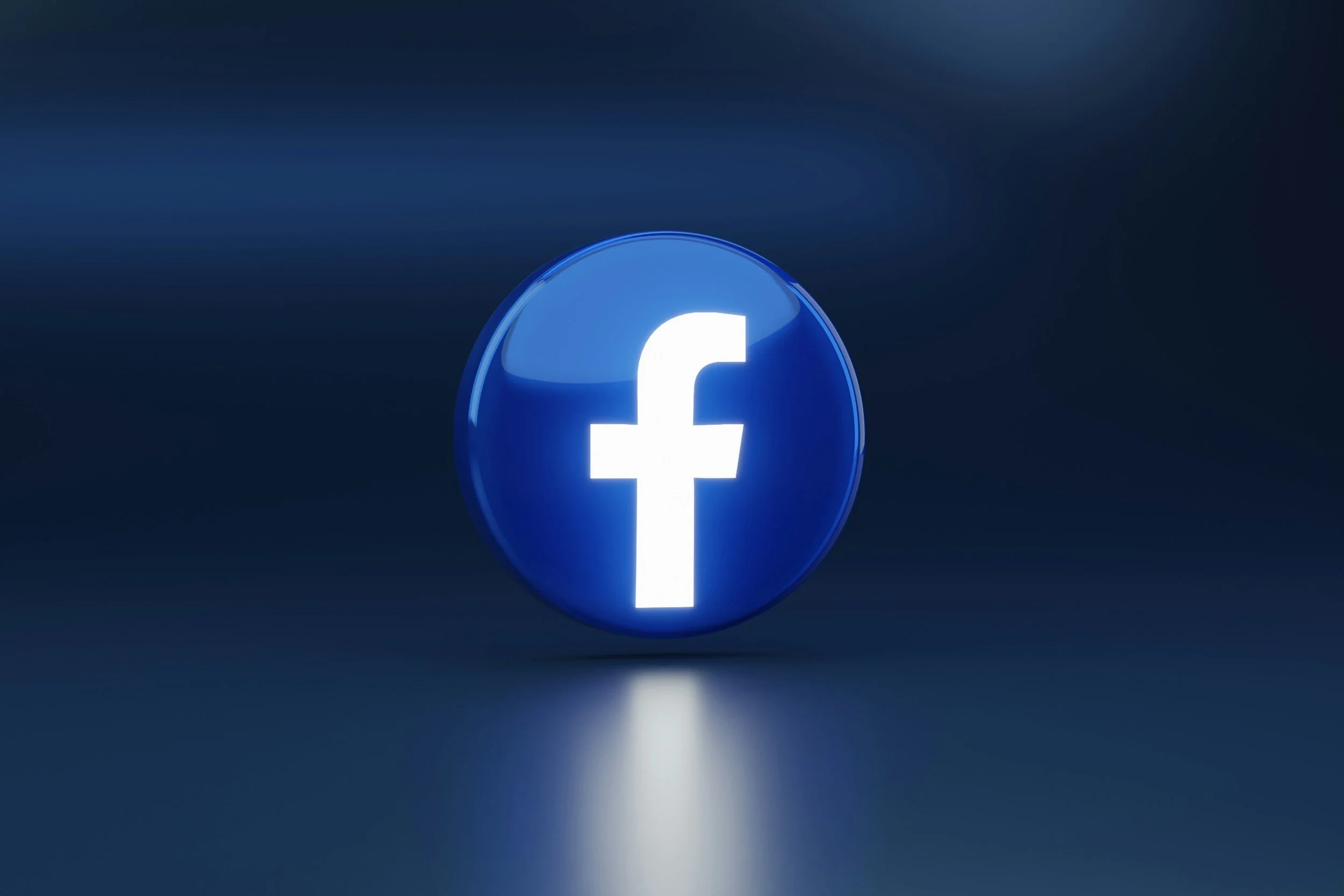 A glowing blue Facebook logo inside a circular shape on a dark background.