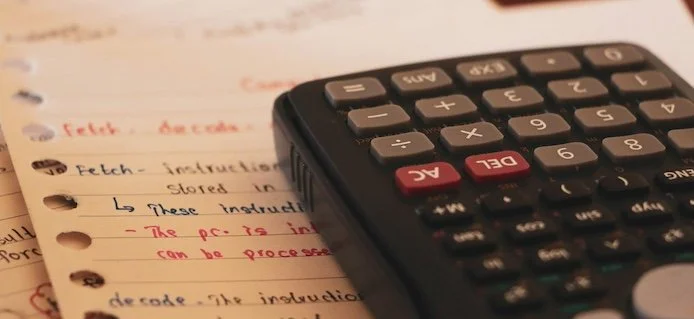 calculator on a piece of paper with writing