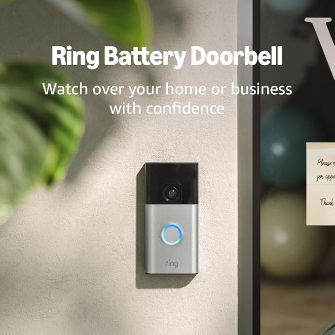 A Ring Battery Doorbell mounted on a wall next to a glass door, with the text 'Ring Battery Doorbell. Watch over your home or business with confidence.'