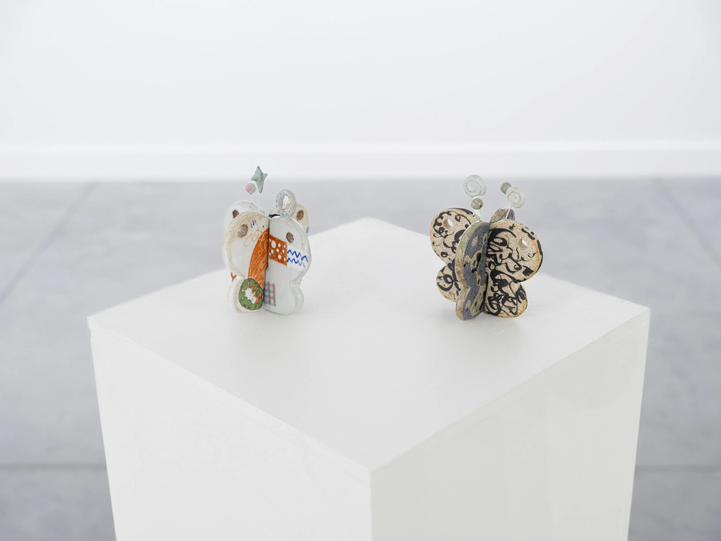 Lulu Luyao Chang / Dream of the Butterfly (Parts 1 + 2), 2025 / glazed stoneware, high-temperature wire, acrylic / 5" x 4.75" x 0.5"