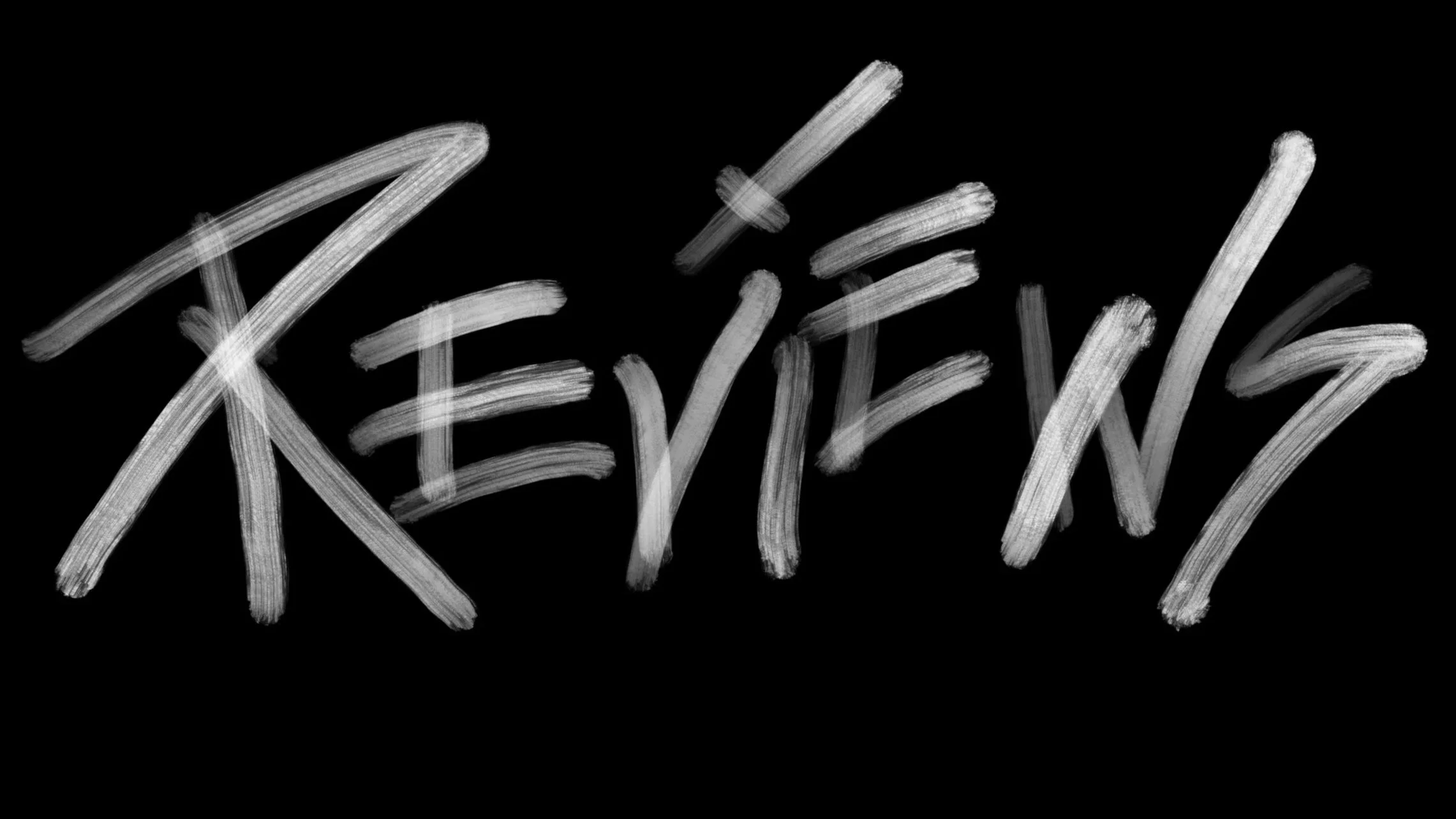 The word 'REVIEW!' written in white chalk on a black chalkboard.