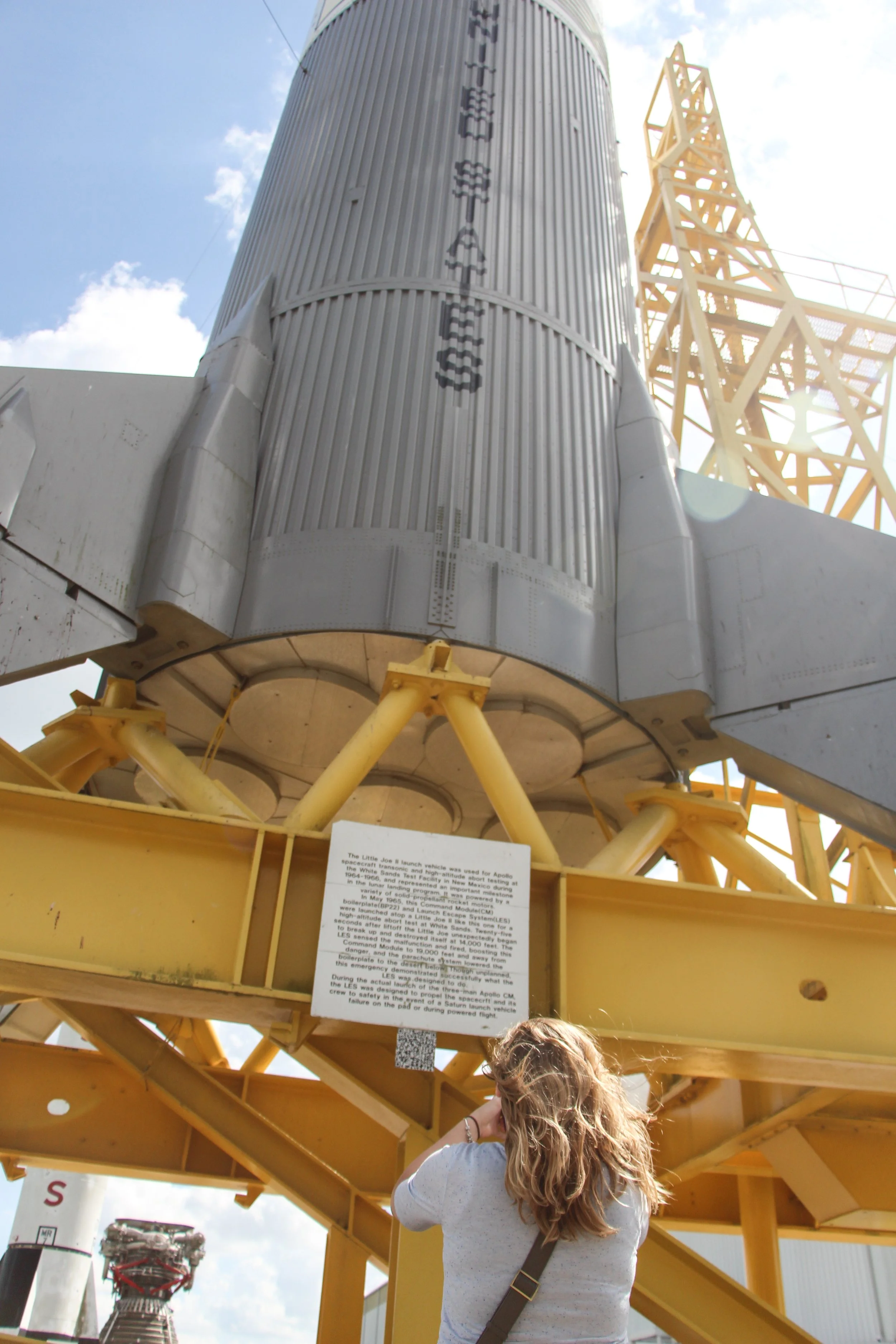 A woman is taking a picture of the Apollo Saturn V rocket at Kennedy Space Center, Florida.