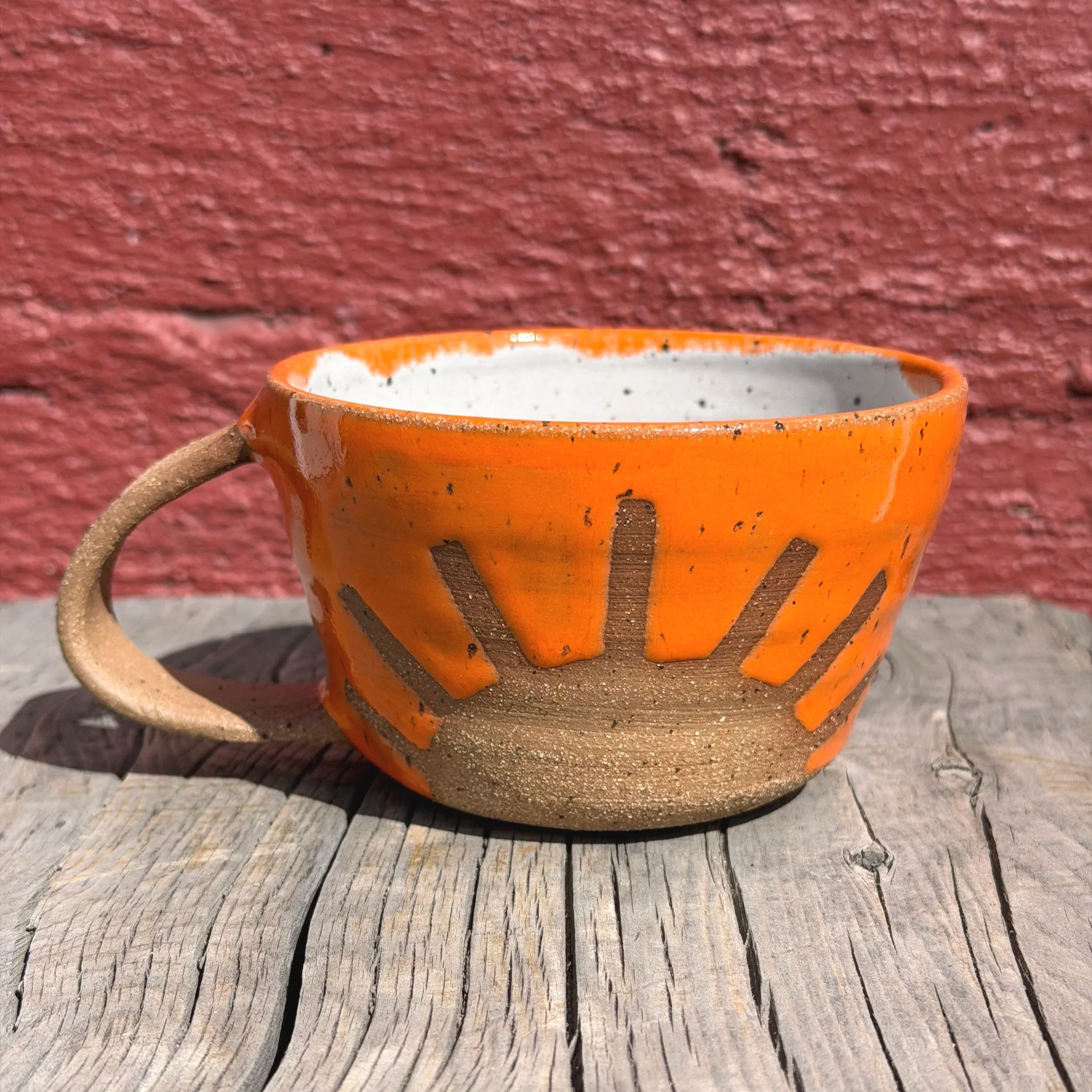 Handmade wheel thrown bright orange sunshine on brown clay with speckles mug modern design stoneware