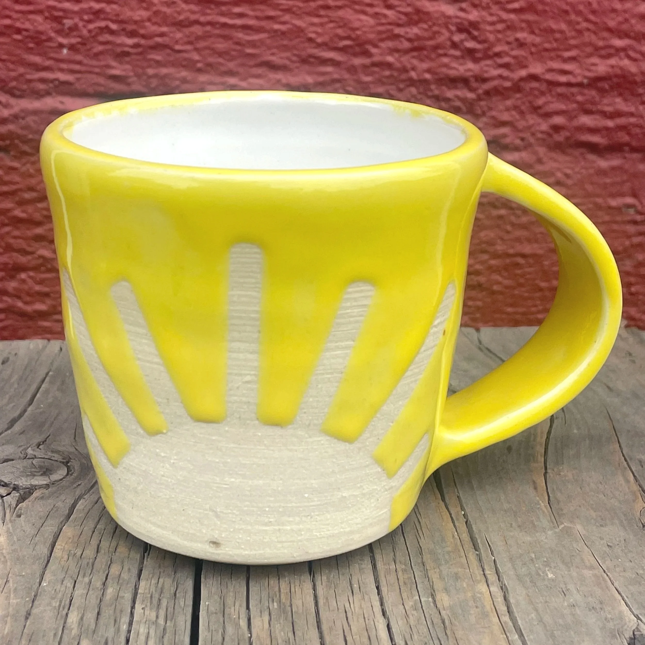 Bright colored sunshine mug in white clay