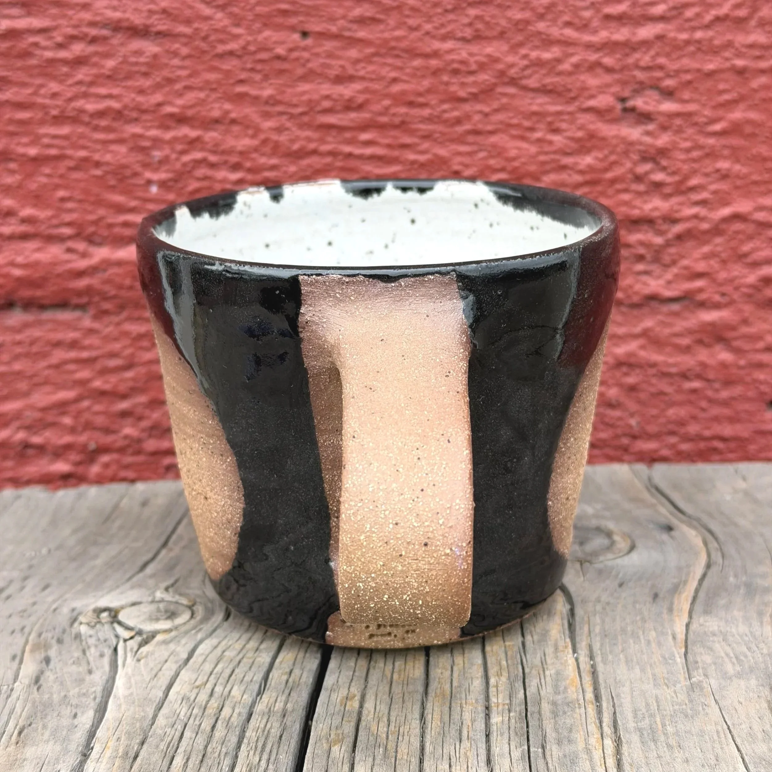Handmade wheel thrown black gloss glaze with circle on brown clay with speckles mug modern design stoneware mid century modern