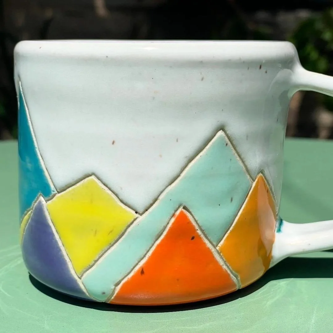 Handmade wheel thrown multi colored mountains on white clay mug modern design stoneware