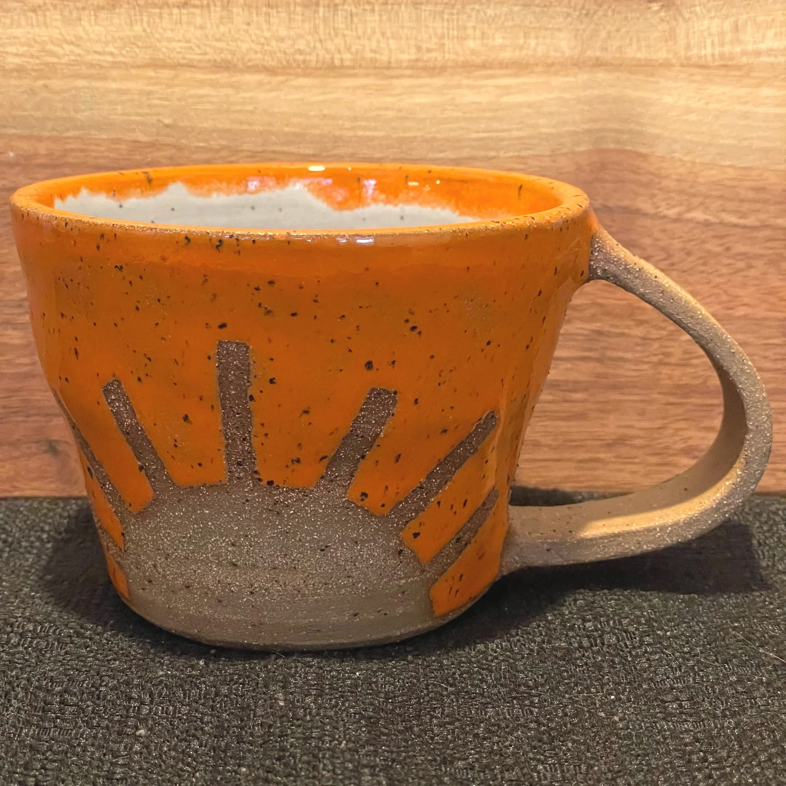 Handmade wheel thrown bright orange sunshine on brown clay with speckles mug modern design stoneware