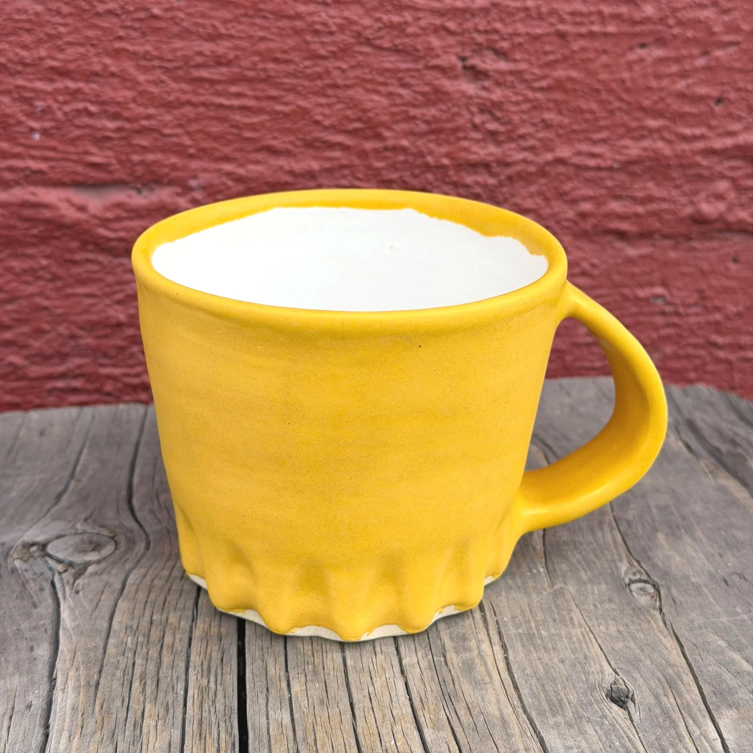Handmade wheel thrown carved tumeric yellow matte glaze on white clay mug modern design stoneware bright