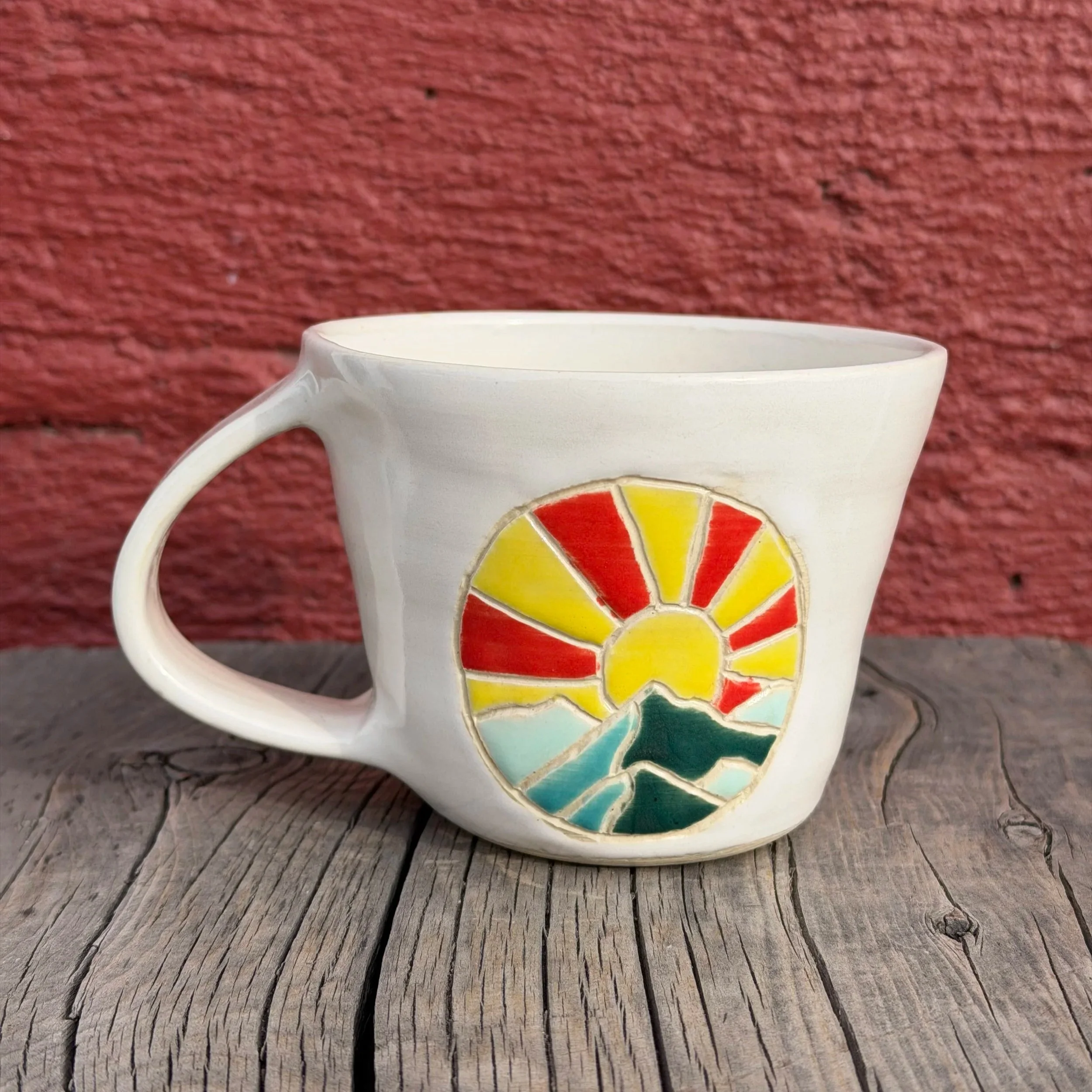 Handmade wheel thrown multi colored sunset and mountains on white clay mug modern design stoneware