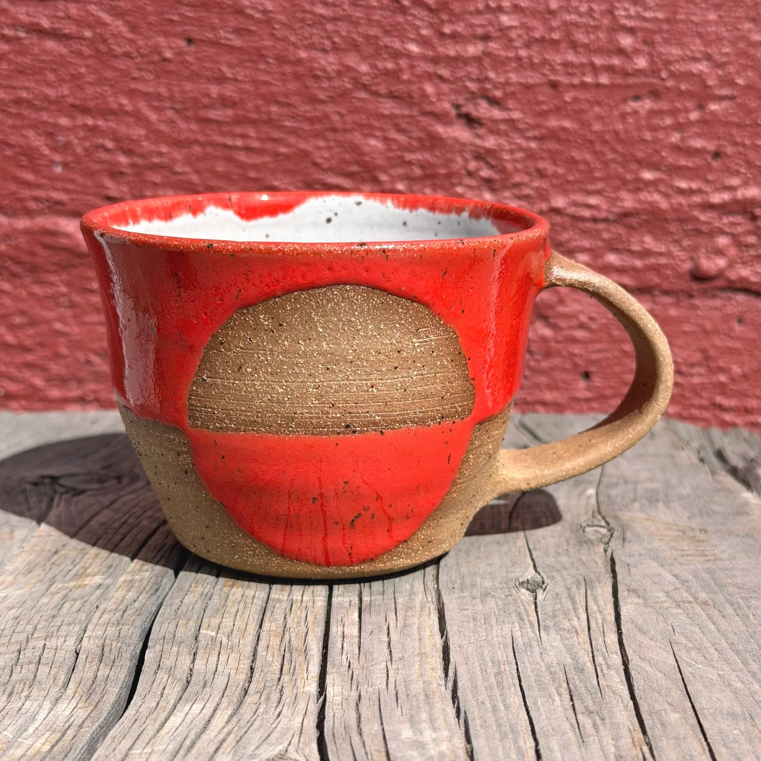 Handmade wheel thrown gloss bright orange glaze with half-circle on brown clay with speckles mug modern design stoneware mid century modern