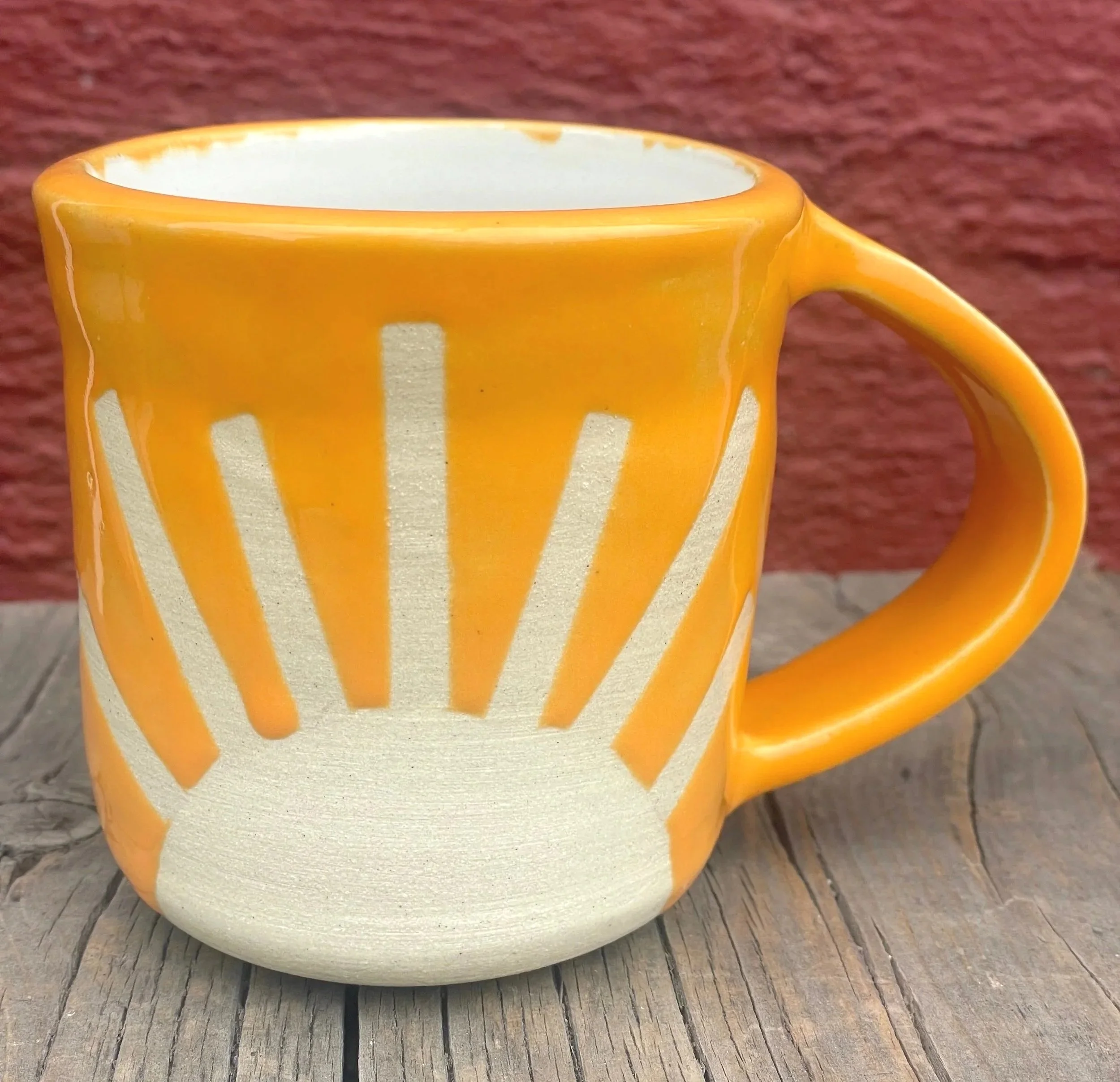 Bright colored sunshine mug in white clay