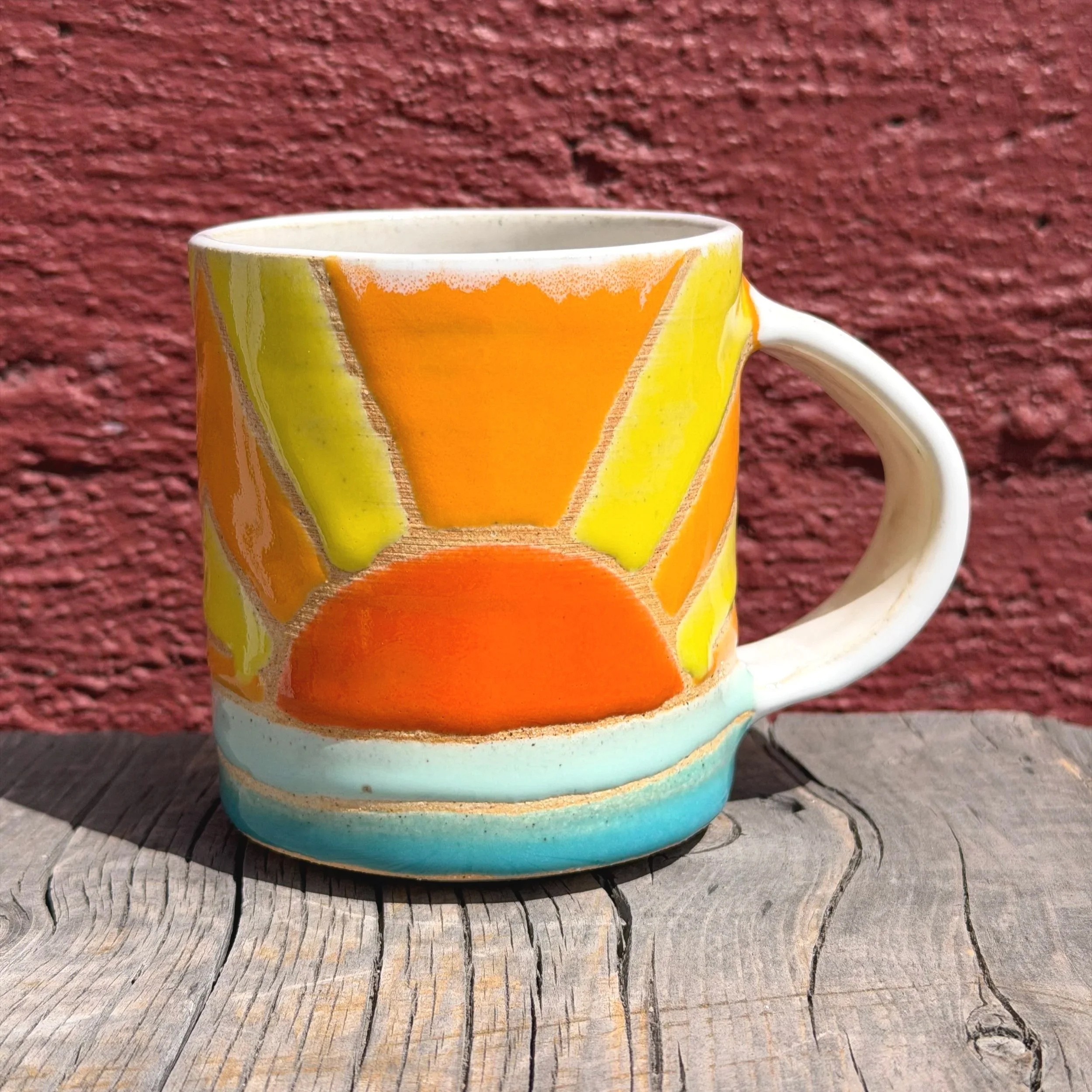 Multi-colored sunshine and water mug in white clay