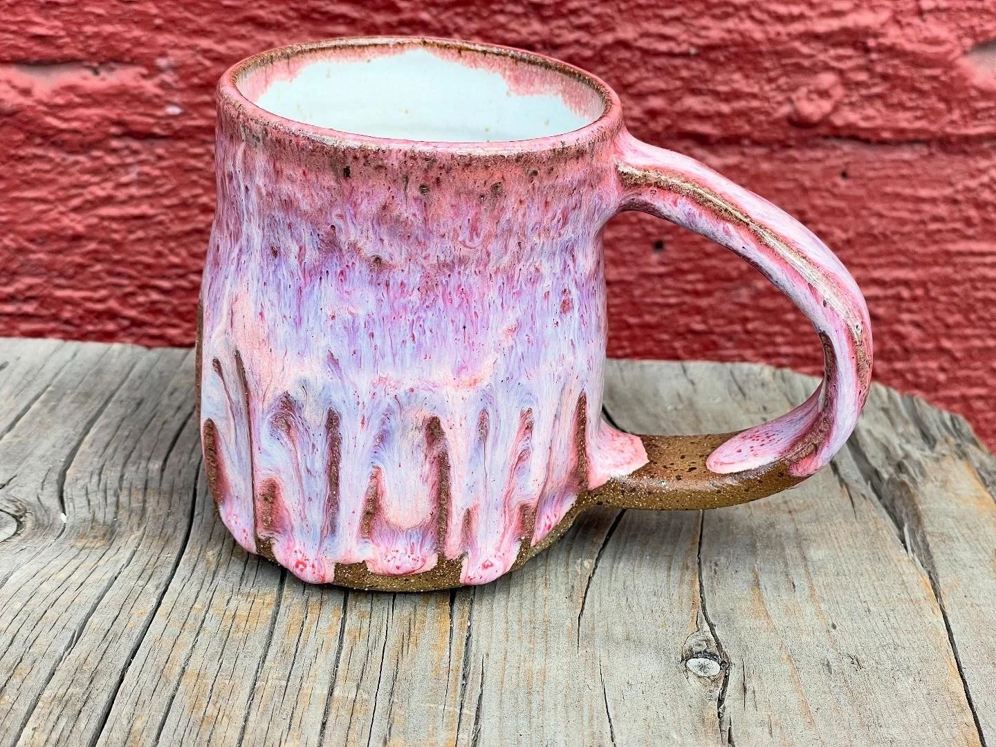 Pink gloss glazed carved mug in brown speckled clay