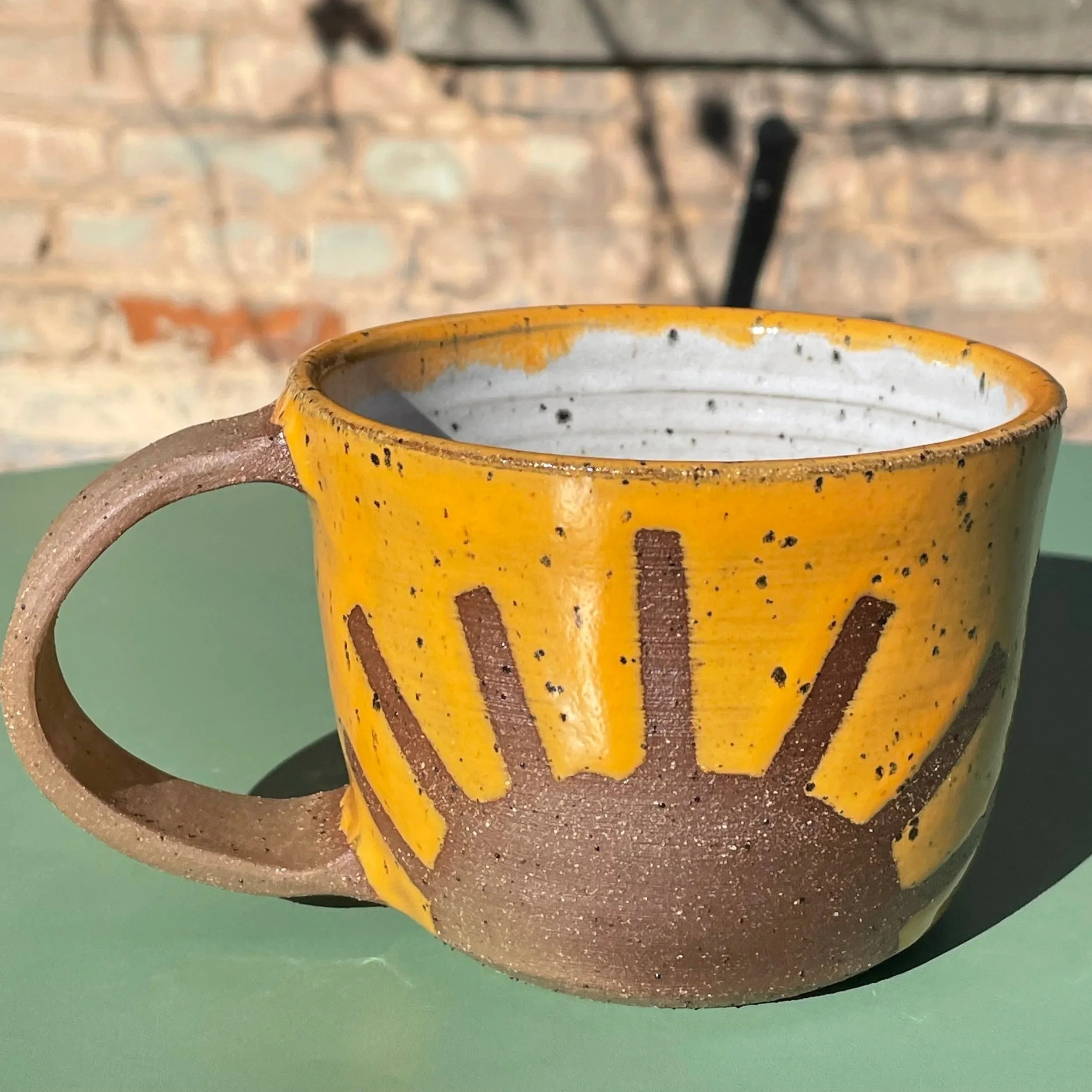 Handmade wheel thrown light orange sunshine on brown clay with speckles mug modern design stoneware