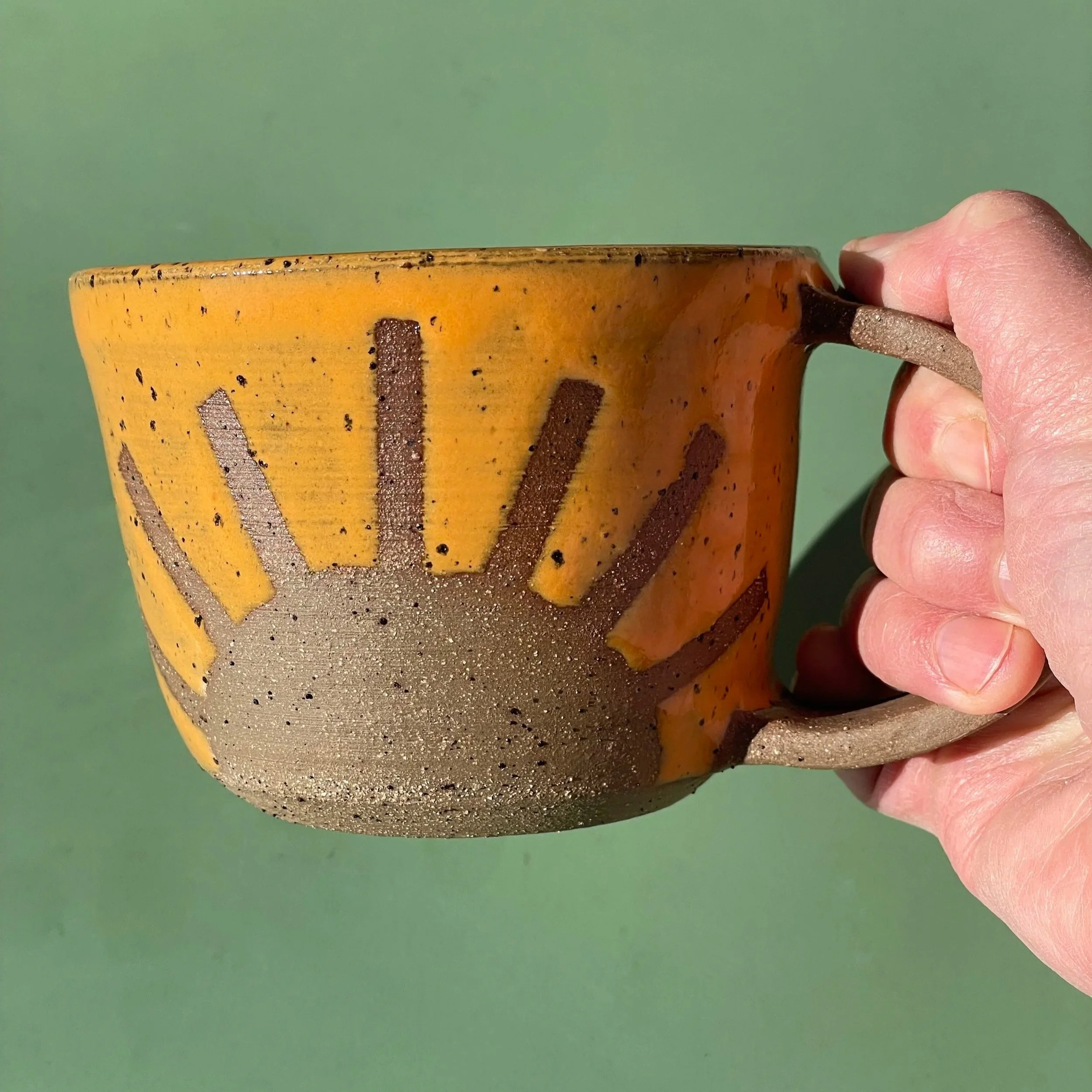 Handmade wheel thrown light orange sunshine on brown clay with speckles mug modern design stoneware