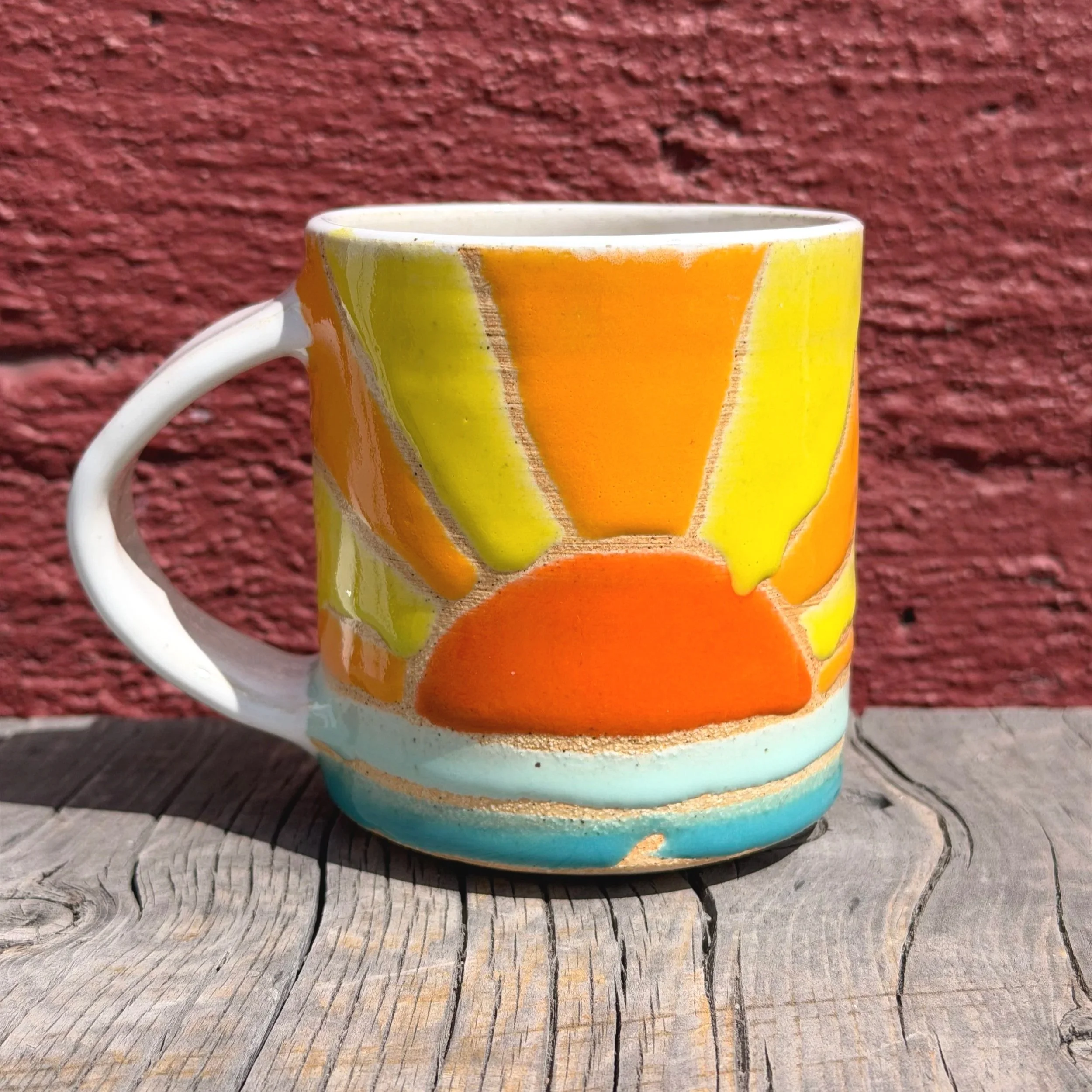 Handmade wheel thrown multi colored sunshine and water on white clay mug modern design stoneware
