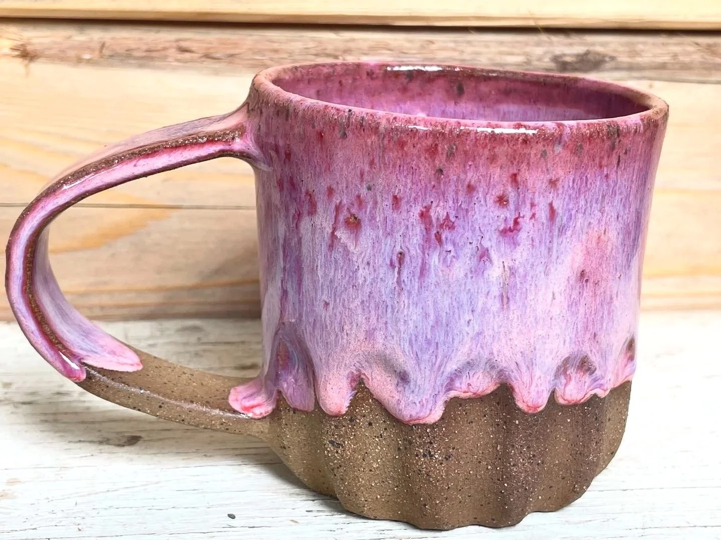 pink gloss glazed carved mug in brown speckled clay