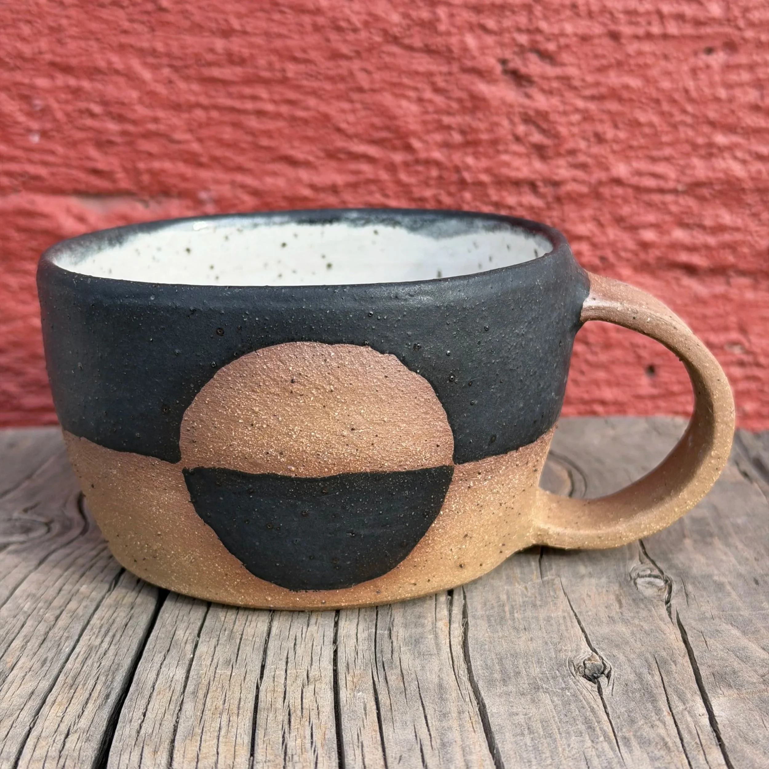 Handmade wheel thrown matte black glaze with half-circle on brown clay with speckles mug modern design stoneware mid century modern